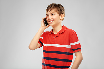 Image showing happy smiling boy calling on smartphone