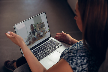 Image showing Close up of young woman getting online medical help and advice during videocall with doctor checking symtoms aand explaining the drug\'s reciepes