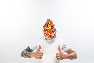 Image showing Male face covered with oilcloth, cellophane and unhealthy food, hard to breathe. People lost their faces, can\'t notice the environmental pollution made by themself.