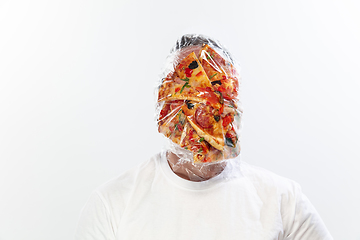 Image showing Male face covered with oilcloth, cellophane and unhealthy food, hard to breathe. People lost their faces, can\'t notice the environmental pollution made by themself.