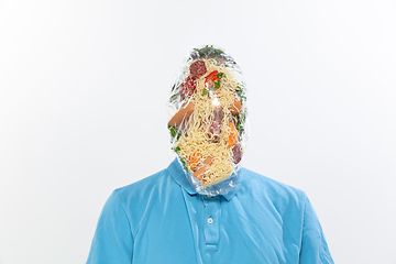 Image showing Male face covered with oilcloth, cellophane and unhealthy food, hard to breathe. People lost their faces, can\'t notice the environmental pollution made by themself.