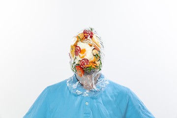 Image showing Male face covered with oilcloth, cellophane and unhealthy food, hard to breathe. People lost their faces, can\'t notice the environmental pollution made by themself.