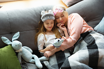 Image showing Mother and daughter, sisters have quite, beauty and fun day together at home. Comfort and togetherness. Waking up in bedroom.