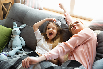 Image showing Mother and daughter, sisters have quite, beauty and fun day together at home. Comfort and togetherness. Waking up in bedroom, good morning.