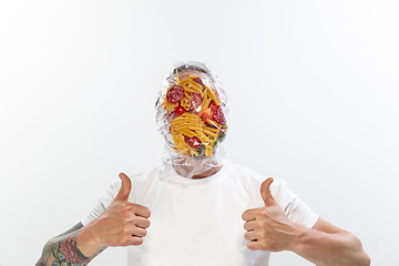 Image showing Male face covered with oilcloth, cellophane and unhealthy food, hard to breathe. People lost their faces, can\'t notice the environmental pollution made by themself.