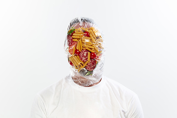 Image showing Male face covered with oilcloth, cellophane and unhealthy food, hard to breathe. People lost their faces, can\'t notice the environmental pollution made by themself.