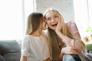 Image showing Mother and daughter, sisters have quite, beauty and fun day together at home. Comfort and togetherness. Telling a secrets, joking.