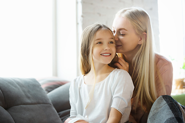 Image showing Mother and daughter, sisters have quite, beauty and fun day together at home. Comfort and togetherness. Telling a secrets, joking.