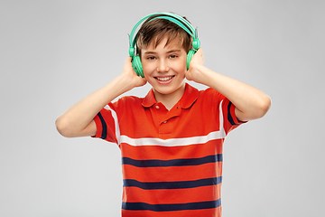 Image showing smiling boy in headphones listening to music