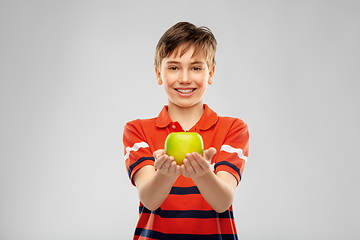 Image showing portrait of happy smiling boy holding green apple