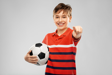 Image showing happy boy with soccer ball pointing to camera