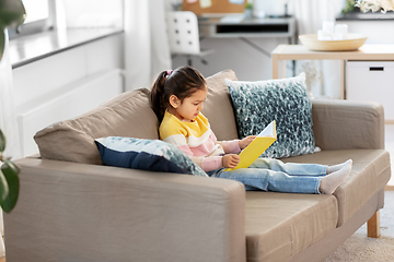 Image showing little girl reading book at home