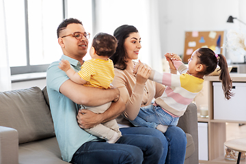 Image showing portrait of happy family sitting on sofa at home