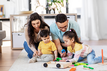 Image showing happy family palying with wooden toys at home