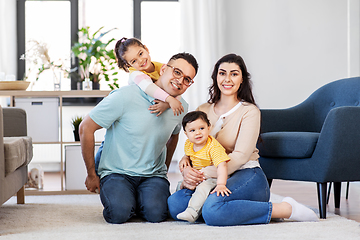 Image showing portrait of happy family sitting on sofa at home