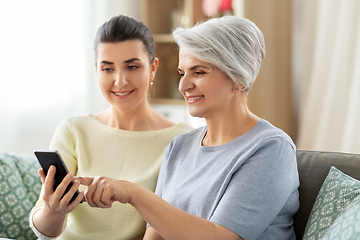 Image showing daughter and senior mother with smartphone at home