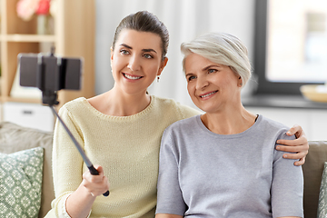 Image showing senior mother with daughter taking selfie at home