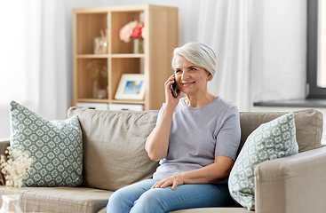 Image showing senior woman calling on smartphone at home