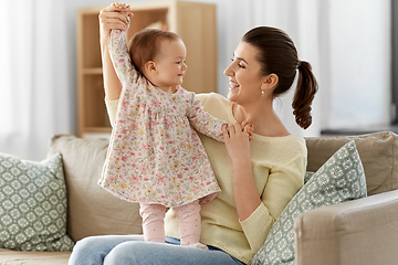 Image showing happy mother with little baby daughter at home