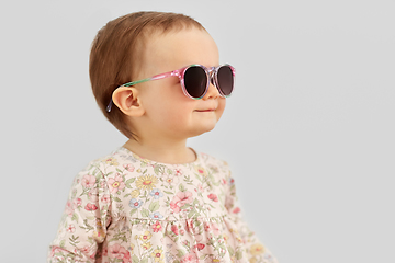 Image showing happy little baby girl in sunglasses over grey