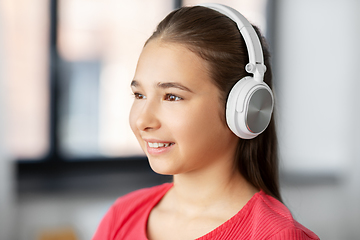 Image showing girl in headphones listening to music at home