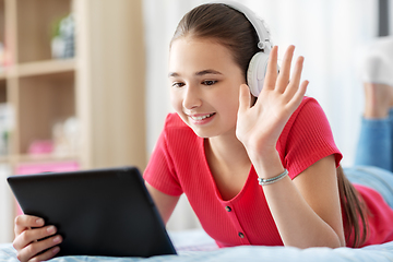 Image showing girl having vide call on tablet computer at home