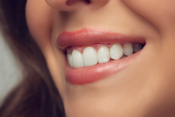 Image showing Close up of beautiful female face, lips and teeth with bright stylish make up isolated on grey studio backgroud