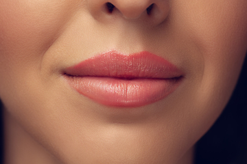 Image showing Close up of beautiful female face, lips with bright stylish make up isolated on grey studio backgroud