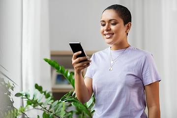 Image showing african american woman with smartphone at home