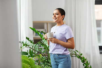 Image showing african american woman drinking coffee at home