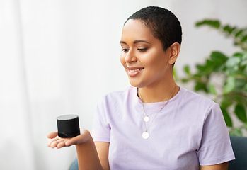 Image showing african american woman with smart speaker at home