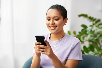 Image showing african american woman with smartphone at home