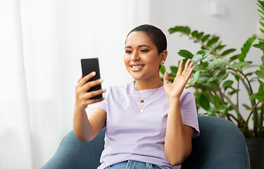 Image showing woman with smartphone having video call at home