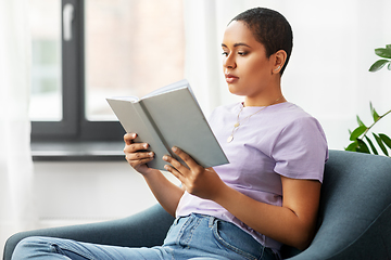 Image showing african american woman reading book at home