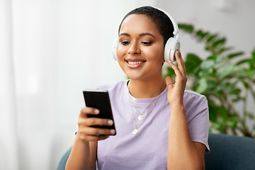 Image showing woman with smartphone listening to music at home