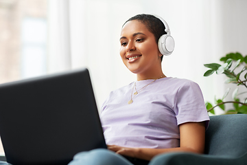 Image showing woman with laptop listening to music at home