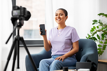 Image showing female blogger with camera video blogging at home