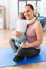 Image showing happy mother with little baby at home