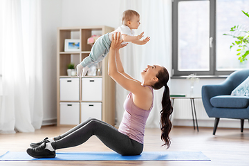 Image showing happy mother with little baby exercising at home