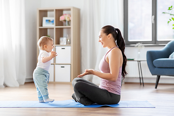 Image showing happy mother with little baby at home