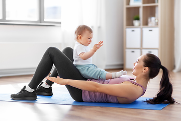 Image showing happy mother with little baby exercising at home