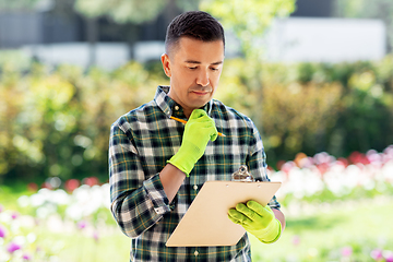 Image showing man with clipboard at summer garden