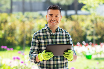 Image showing happy man with tablet pc at summer garden