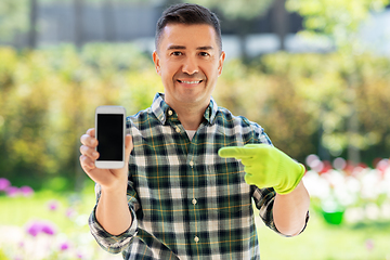 Image showing middle-aged man with smartphone at summer garden