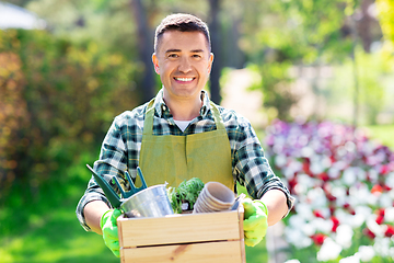 Image showing happy man with tools in box at summer garden