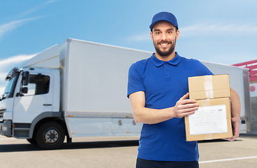 Image showing happy delivery man with parcel boxes