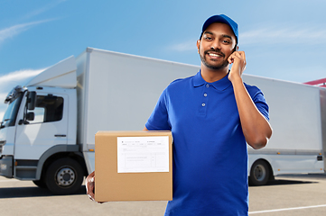 Image showing indian delivery man with smartphone and parcel box