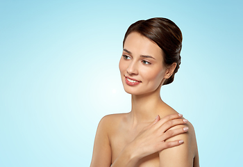 Image showing beautiful young woman touching bare shoulder