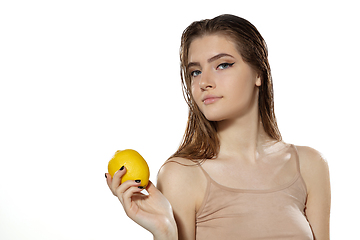 Image showing Youth secrets. Beautiful young woman with lemon over white background. Cosmetics and makeup, natural and eco treatment, skin care.