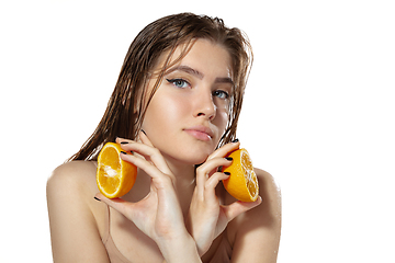 Image showing Organic. Beautiful young woman with orange slices over white background. Cosmetics and makeup, natural and eco treatment, skin care.